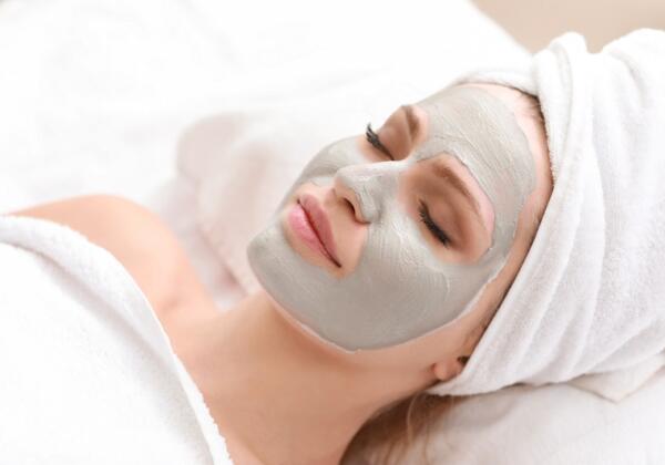 Young Woman With Facial Mask In Beauty Salon